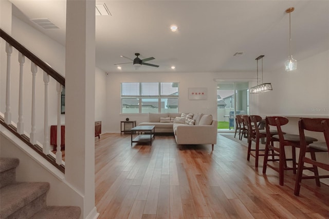 living room with ceiling fan and light hardwood / wood-style floors