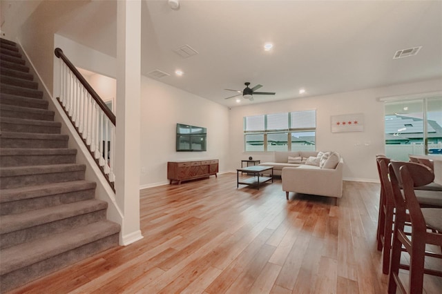 living room featuring ceiling fan and light wood-type flooring