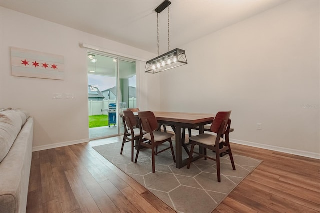 dining space with hardwood / wood-style flooring