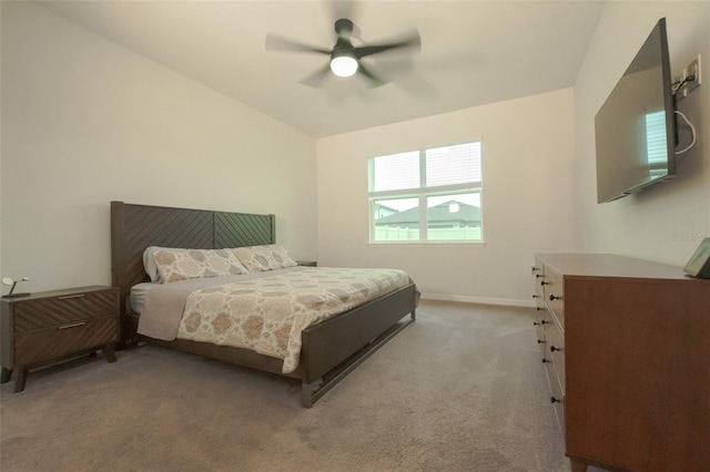 carpeted bedroom featuring ceiling fan and vaulted ceiling