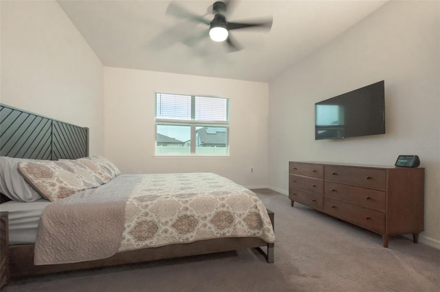 bedroom with ceiling fan, light colored carpet, and vaulted ceiling