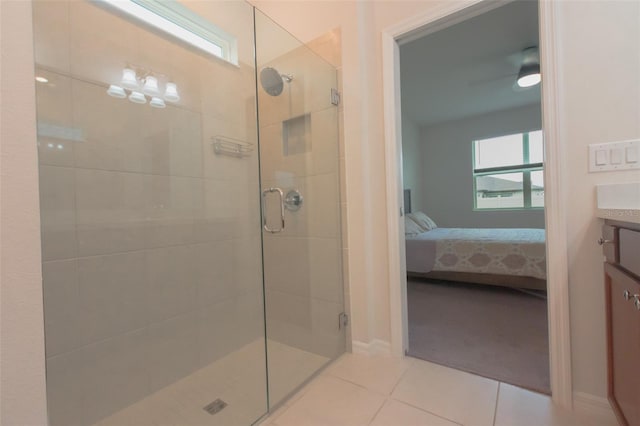 bathroom with a shower with shower door, tile patterned floors, vanity, and ceiling fan