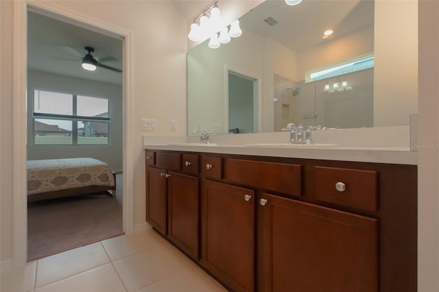 bathroom with vanity, ceiling fan, tile patterned flooring, and walk in shower