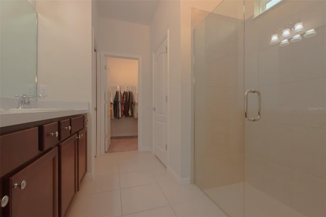 bathroom with vanity, tile patterned floors, and a shower with door