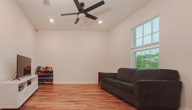 living room featuring ceiling fan and light wood-type flooring