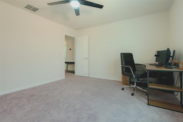 office space featuring ceiling fan and light colored carpet