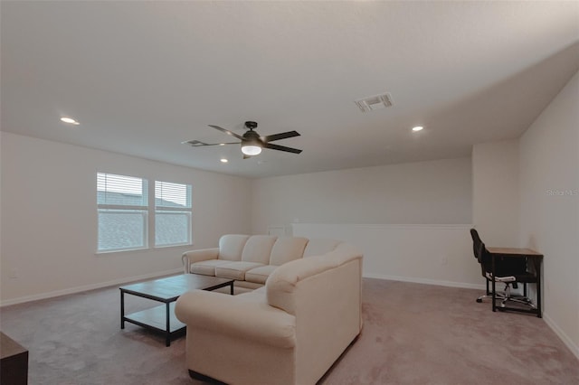 living room featuring ceiling fan and light colored carpet