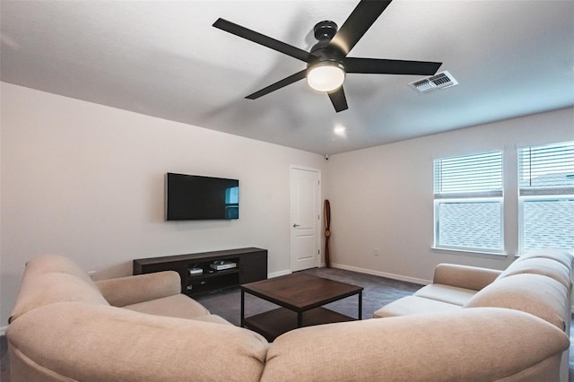 carpeted living room featuring ceiling fan