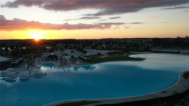 view of pool at dusk