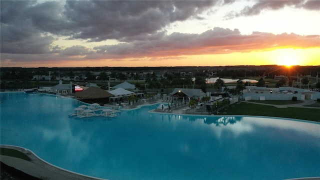 view of pool at dusk