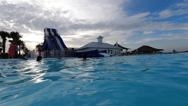 view of pool at dusk