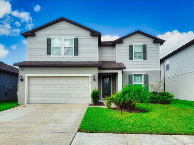 front facade with a front yard and a garage