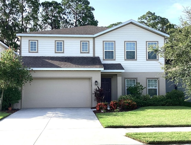 front facade featuring a garage and a front lawn