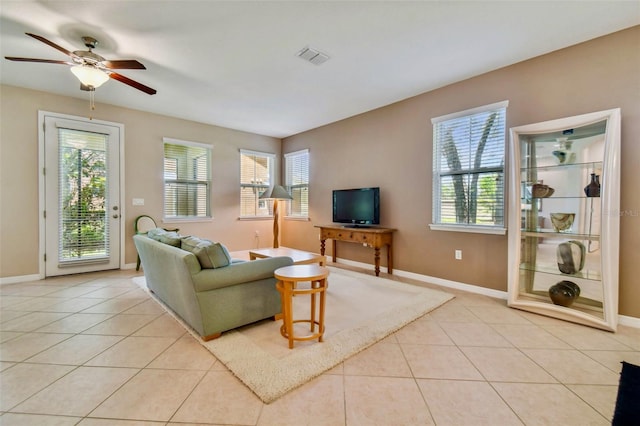 tiled living room featuring ceiling fan and a healthy amount of sunlight