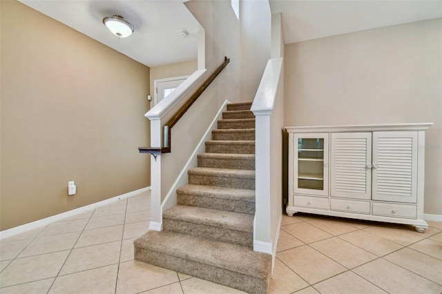 staircase featuring tile patterned floors