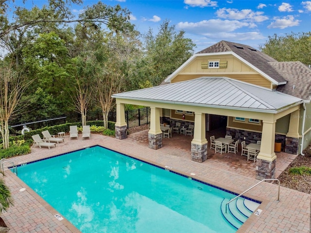 view of swimming pool with a patio and an outdoor bar