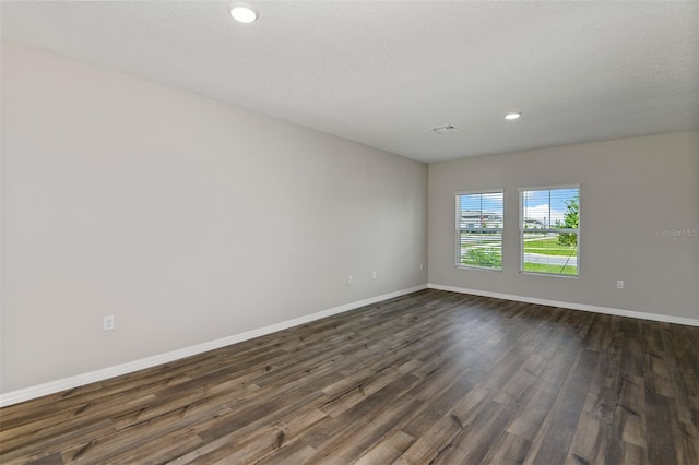 empty room with dark hardwood / wood-style floors