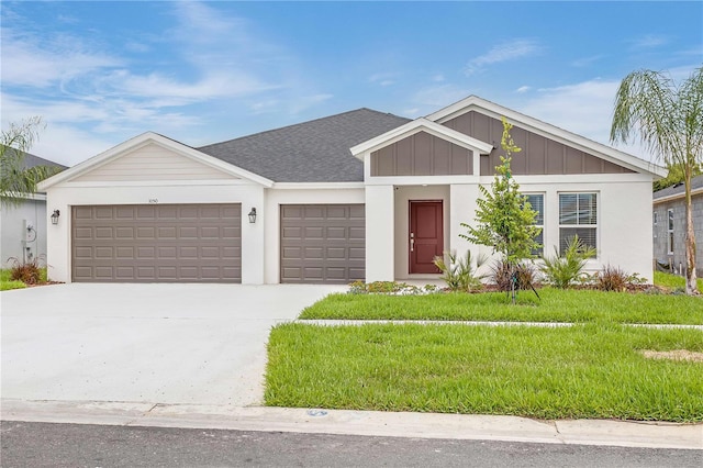 ranch-style house featuring a front lawn and a garage