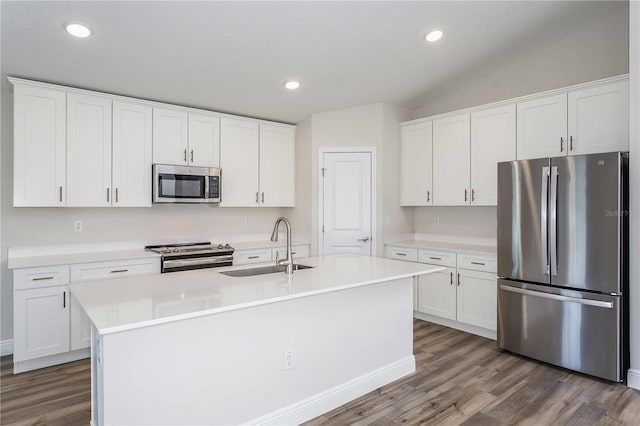 kitchen featuring appliances with stainless steel finishes, sink, white cabinets, and an island with sink