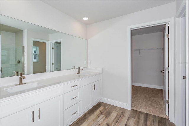 bathroom with vanity, wood-type flooring, and walk in shower