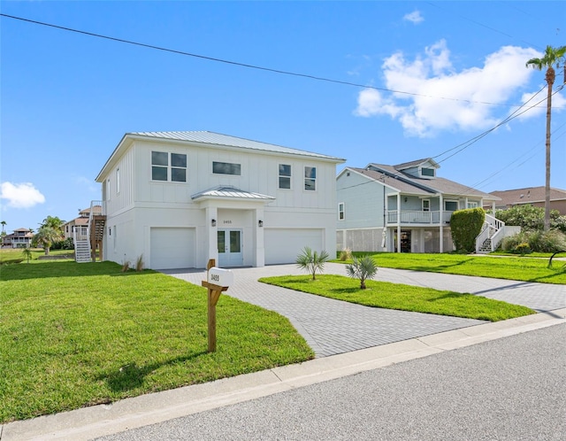 view of front of property with a garage and a front lawn