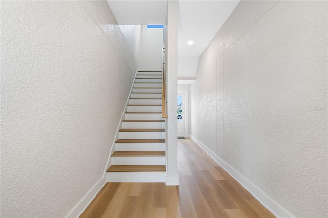 stairs featuring hardwood / wood-style flooring