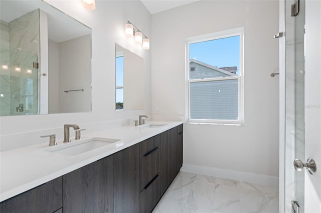 bathroom featuring a healthy amount of sunlight, vanity, and a shower with door