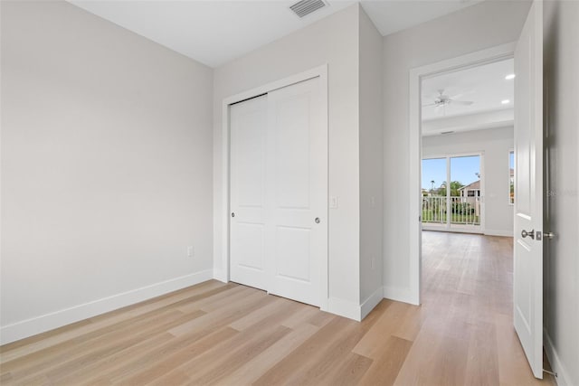 unfurnished bedroom featuring a closet and light hardwood / wood-style flooring