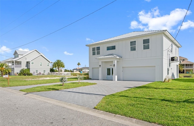 view of front of property with a garage and a front lawn