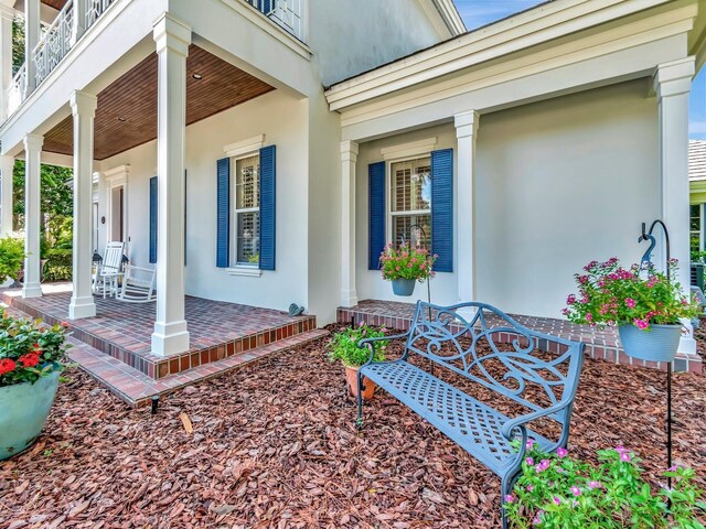 entrance to property with a balcony and covered porch