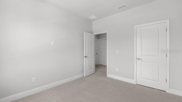 unfurnished bedroom featuring light carpet