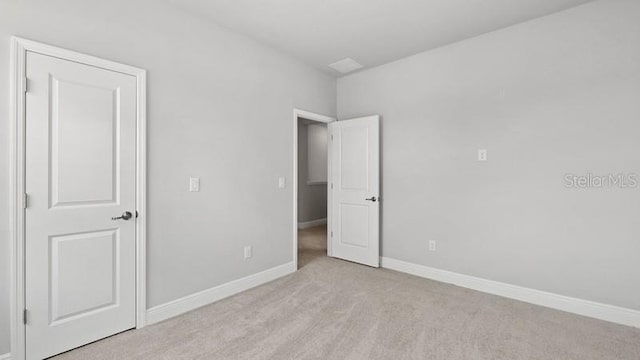 unfurnished bedroom with light colored carpet