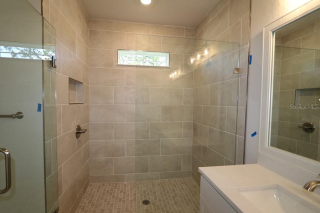 bathroom with vanity and a shower with door