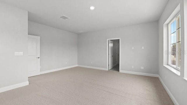 carpeted spare room with a wealth of natural light