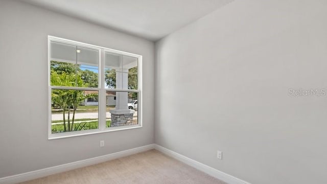 unfurnished room with light carpet