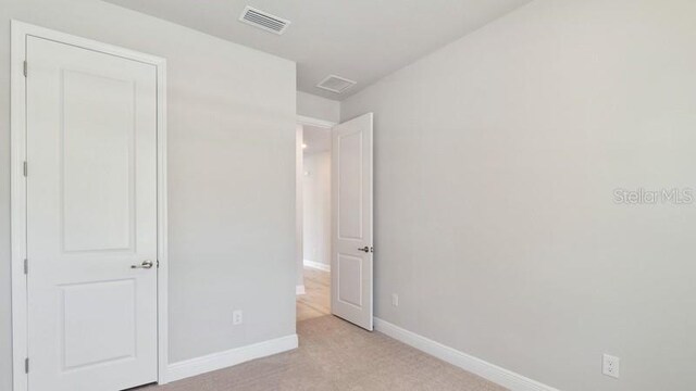 unfurnished bedroom featuring light colored carpet