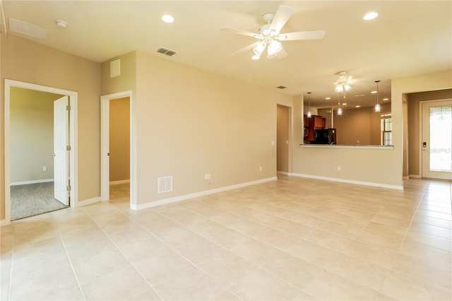 unfurnished living room featuring light tile patterned floors and ceiling fan