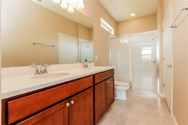 bathroom with plenty of natural light, double vanity, tile patterned flooring, and toilet