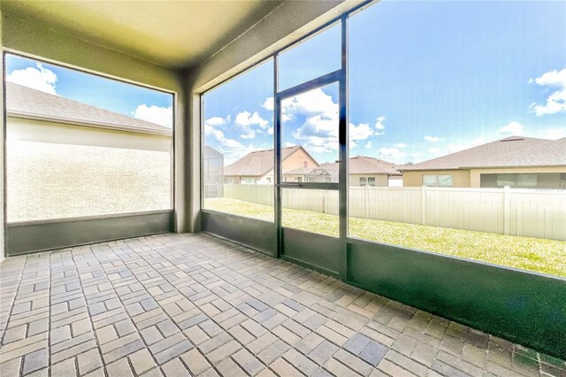 406 Tortosa Ct, Davenport, FL 33837 - unfurnished sunroom featuring a residential view