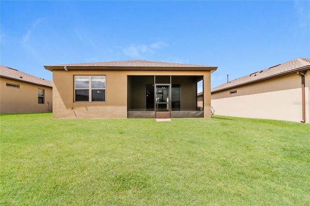 406 Tortosa Ct, Davenport, FL 33837 - rear view of property with a sunroom, a lawn, and stucco siding