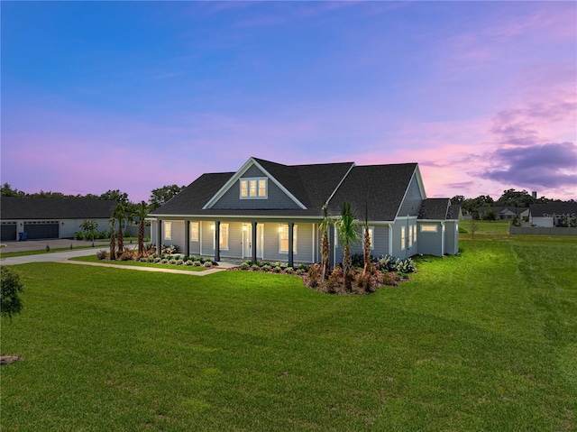 view of front of house with covered porch, an outdoor structure, and a lawn