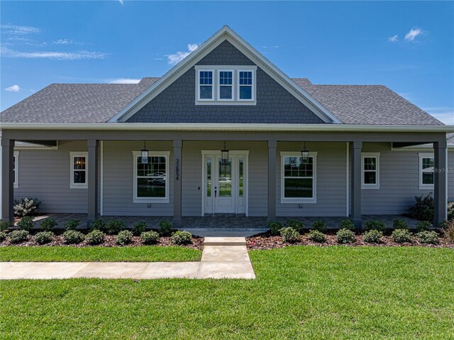 view of front of house featuring a front lawn and covered porch