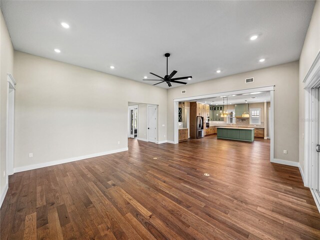 unfurnished living room with hardwood / wood-style flooring and ceiling fan