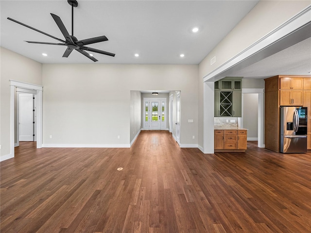 unfurnished living room with dark hardwood / wood-style floors and ceiling fan