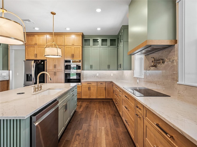 kitchen with stainless steel appliances, wall chimney range hood, sink, backsplash, and dark hardwood / wood-style flooring