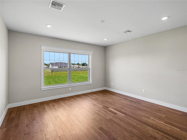 unfurnished room with wood-type flooring