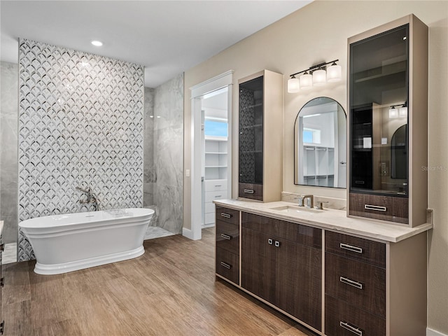 bathroom featuring vanity, a bathing tub, and tile walls