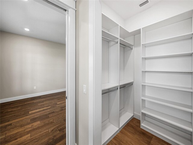 walk in closet featuring dark hardwood / wood-style flooring