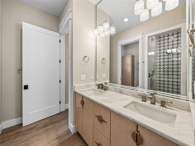 bathroom featuring wood-type flooring and double vanity