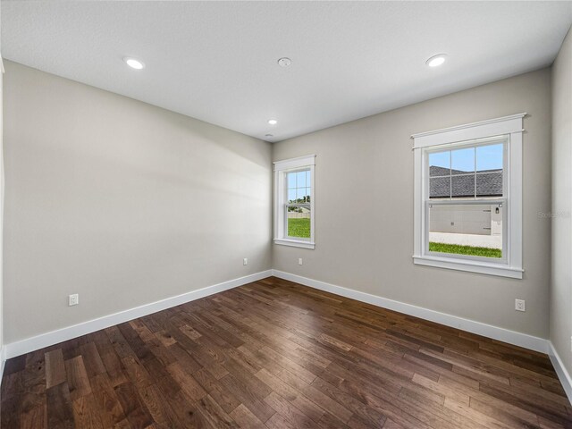 spare room with wood-type flooring